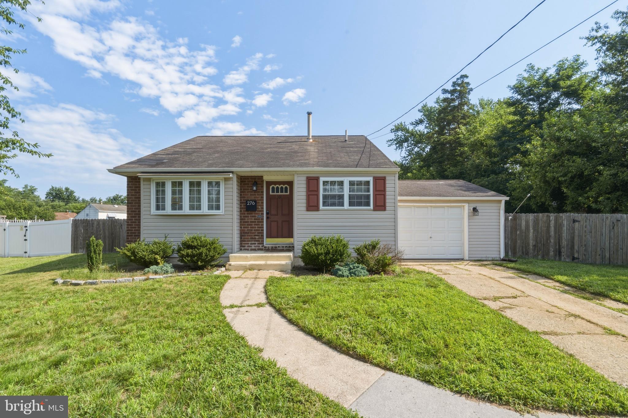 276 Madison Road Mantua, NJ 08051 - Photo 1 of 30 a front view of a house with a yard and garage