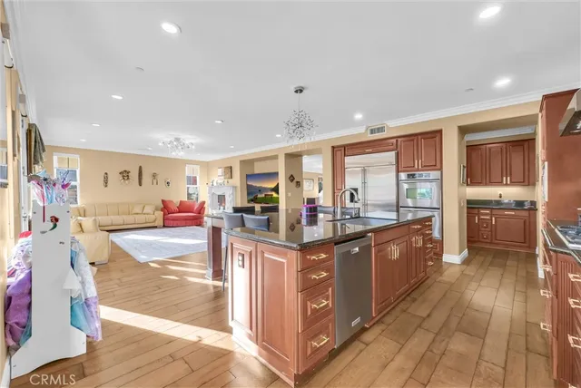 a kitchen with granite countertop a refrigerator and cabinets
