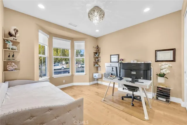 a bedroom with a bed and a chandelier