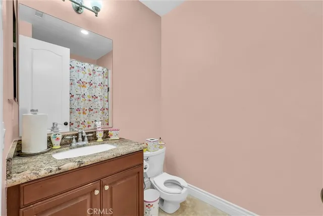 a living room with a bed furniture and next to a window