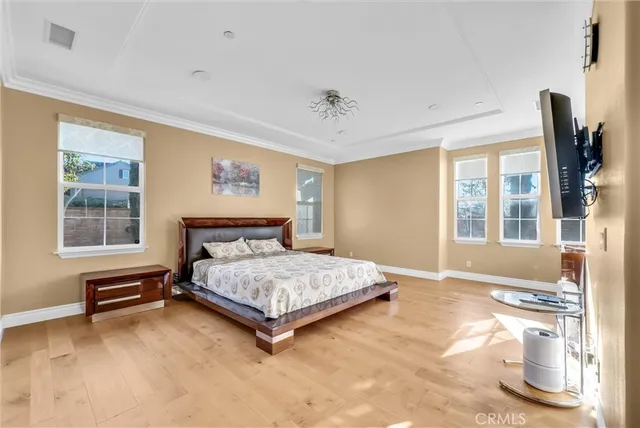 a bedroom with furniture and a large window