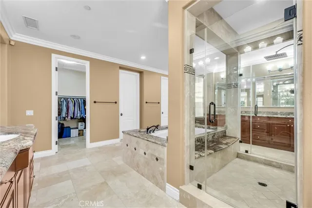 a bathroom with a granite countertop sink mirror and shower