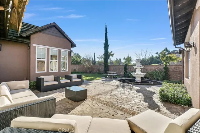 a view of a patio with a table chairs and a backyard
