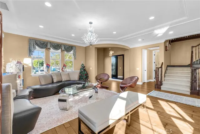 a living room with furniture and a chandelier