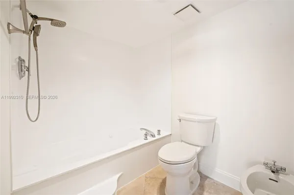 a bathroom with a double vanity sink a large mirror and shower