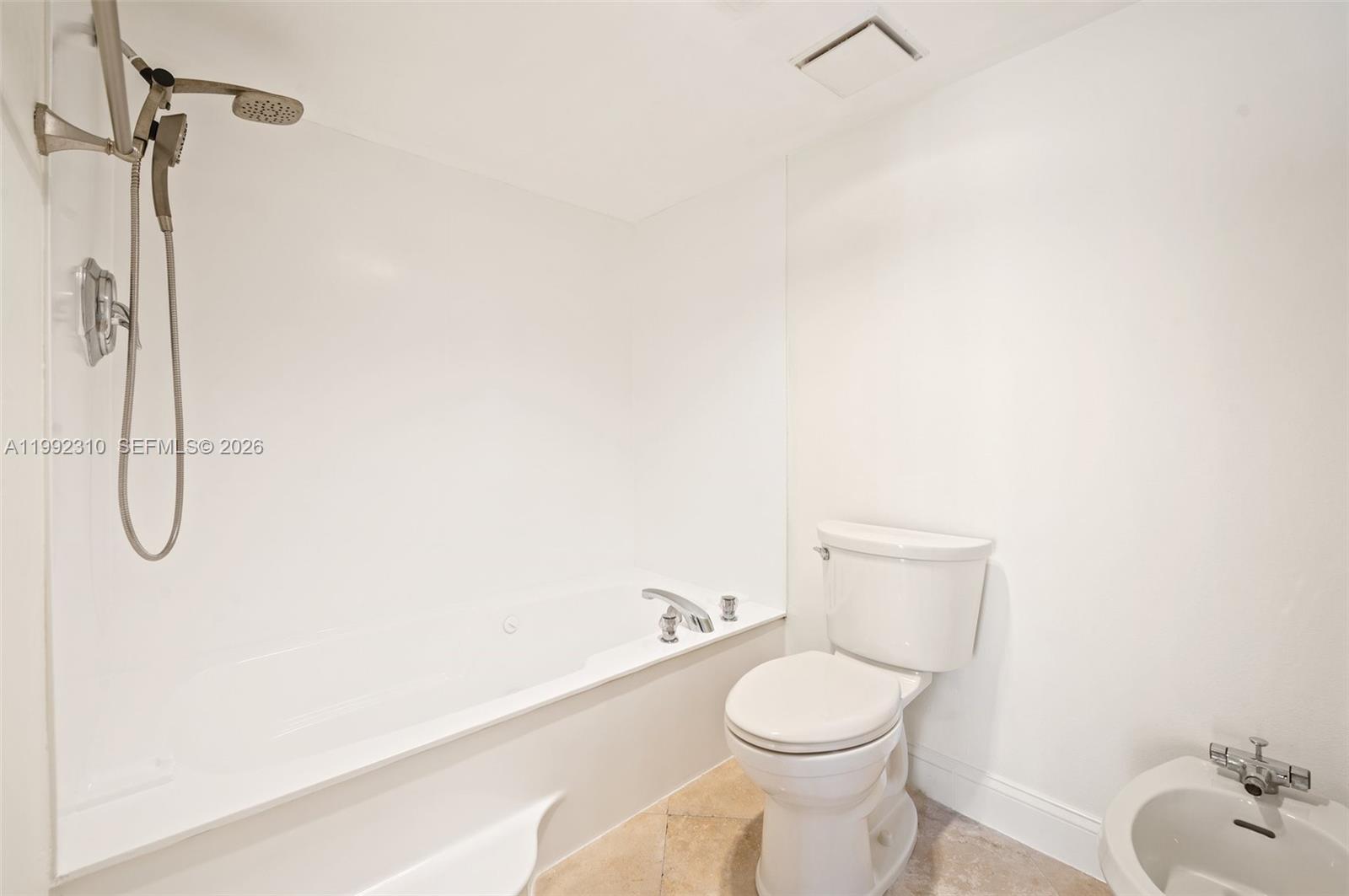 520 Brickell Key Drive, Unit A1712 Miami, FL 33131 - Photo 19 of 34 a white toilet sitting next to a bathroom sink