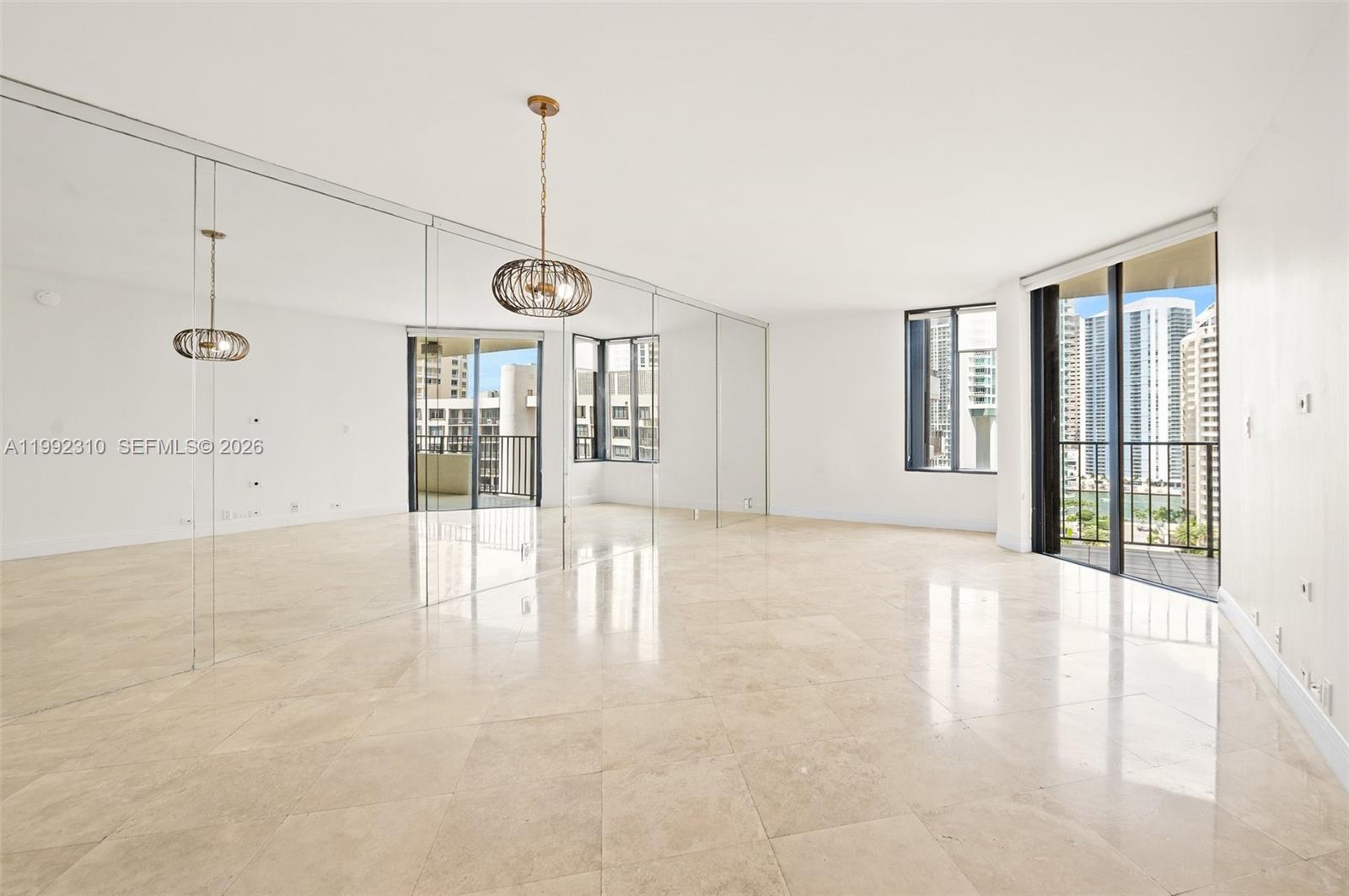 520 Brickell Key Drive, Unit A1712 Miami, FL 33131 - Photo 3 of 34 a view of an empty room with glass door and windows