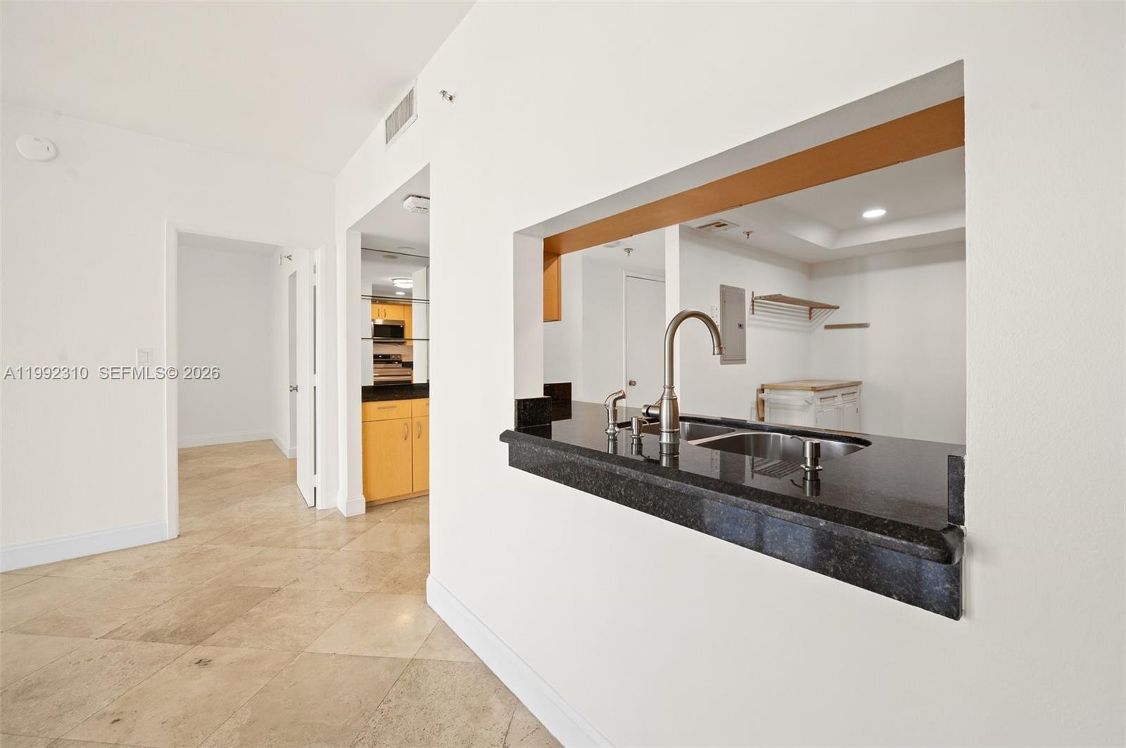520 Brickell Key Drive, Unit A1712 Miami, FL 33131 - Photo 10 of 34 a kitchen with granite countertop a sink and cabinets