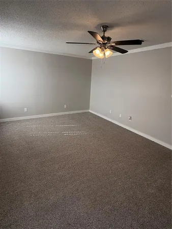 a view of an empty room with a fan