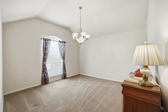 a room with furniture and a chandelier fan