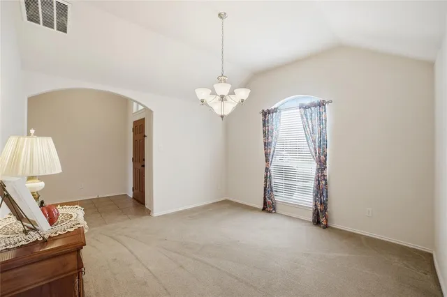 a view of a room with window and chandelier