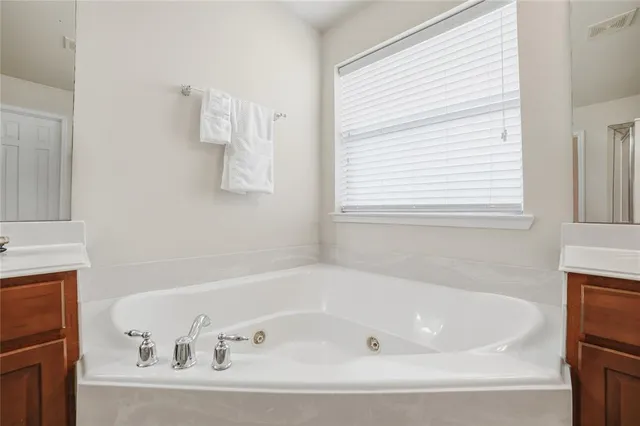 a white bath tub sitting next to a window