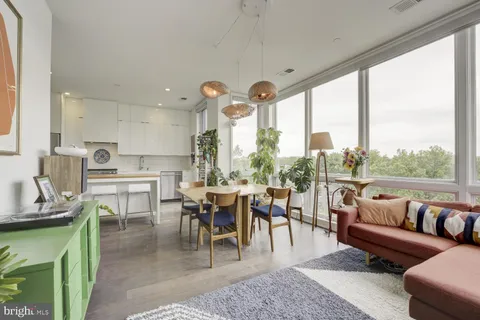 a living room with lots of furniture and a large window