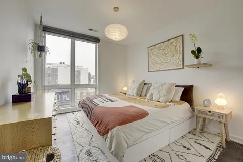 a bedroom with a large bed and a large window