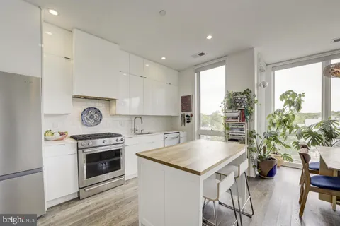 a kitchen with a stove a refrigerator and a refrigerator