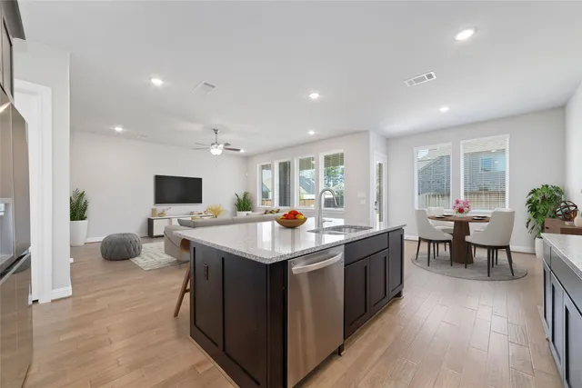 a kitchen with counter top space and living room