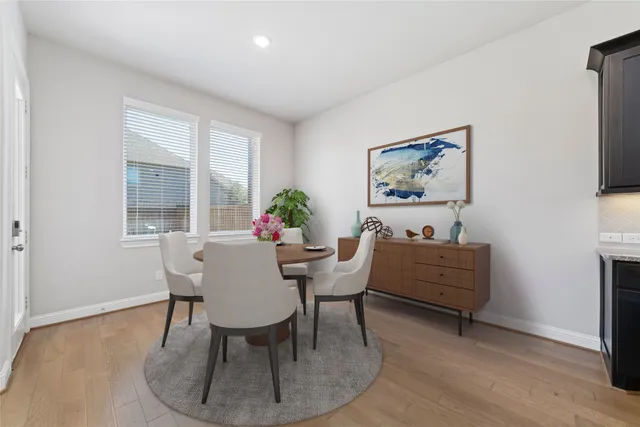 a dining room with furniture and window