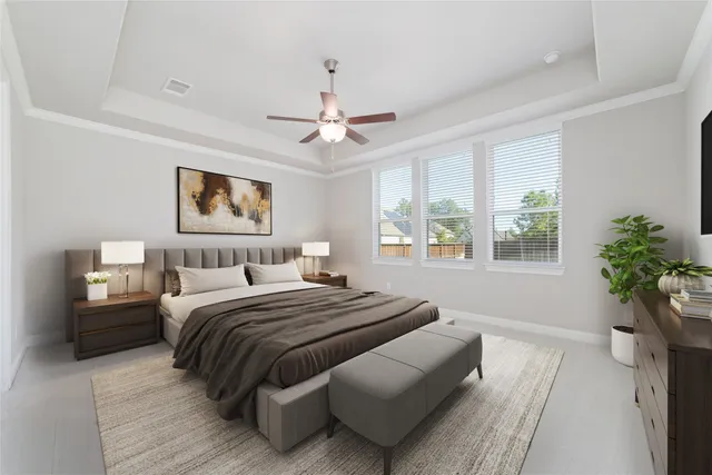 a bedroom with a large bed and a chandelier fan