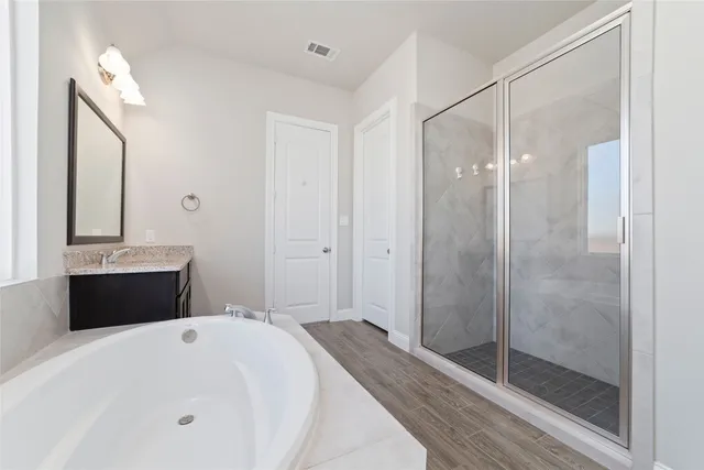 a bathroom with a bathtub a sink and a mirror