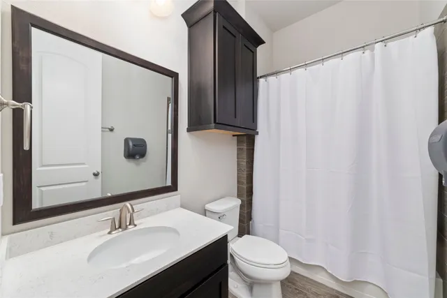 a bathroom with a sink toilet and shower