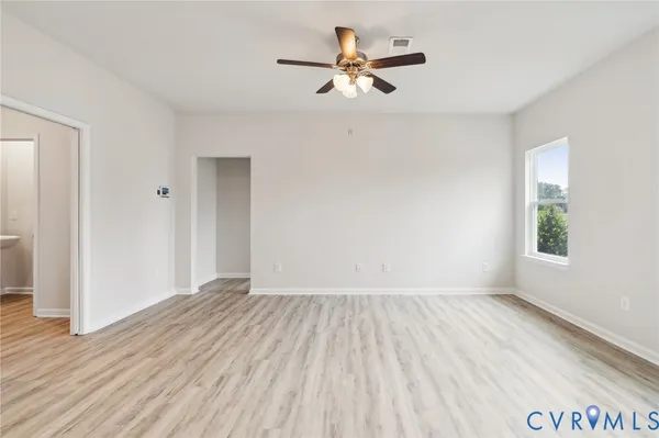 wooden floor in an empty room with a window
