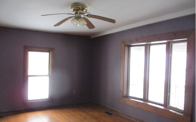24902 Poplar Road Genoa, IL 60135 - Photo 3 of 11 an empty room with windows and fan