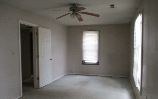 24902 Poplar Road Genoa, IL 60135 - Photo 7 of 11 a view of empty room with windows and ceiling fan