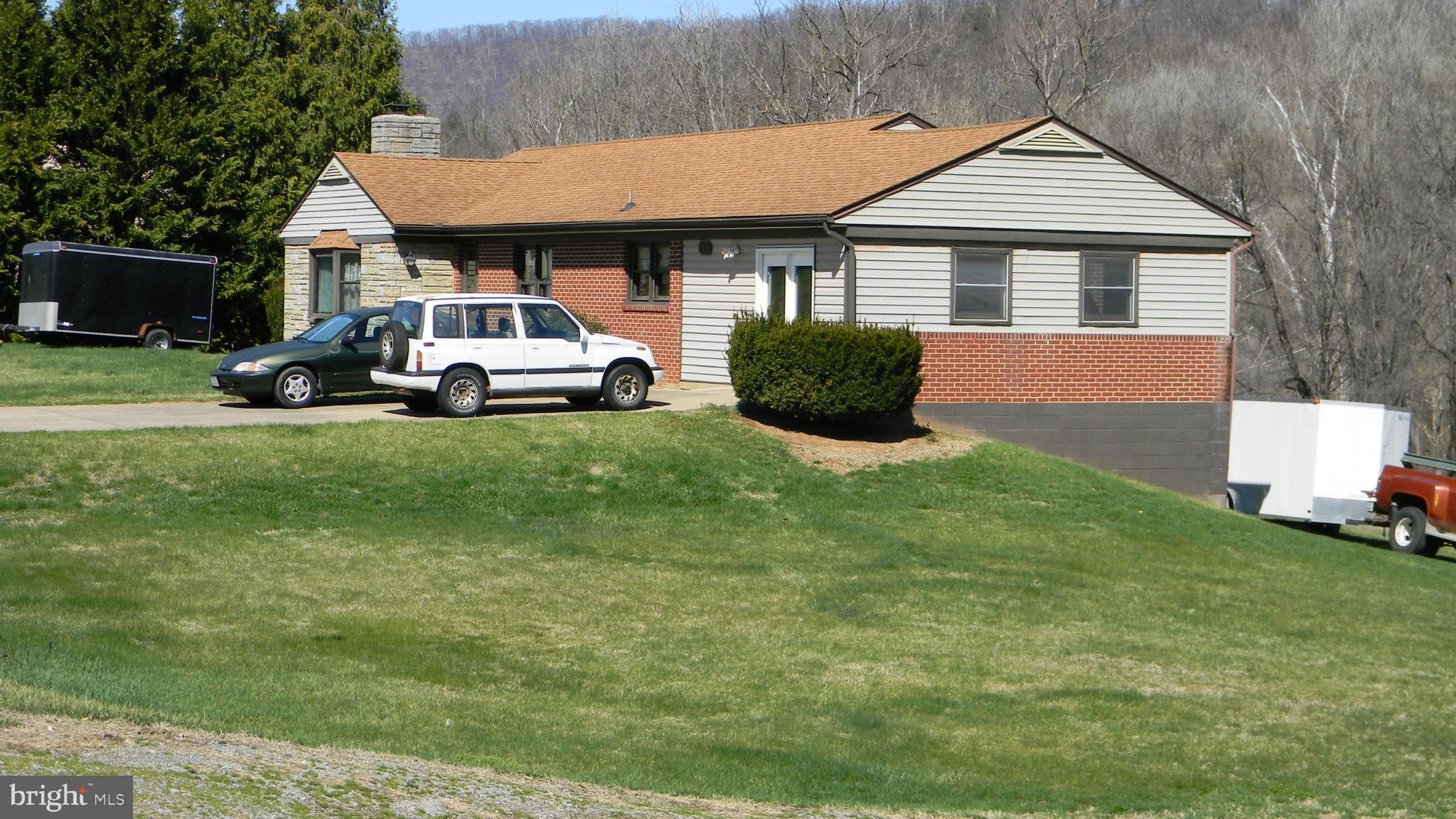 6688 Brocks Gap Road Broadway, VA 22815 - Photo 1 of 81 a front view of a house with a garden and trees