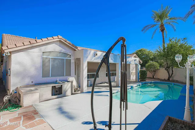 a view of a house with backyard porch and sitting area