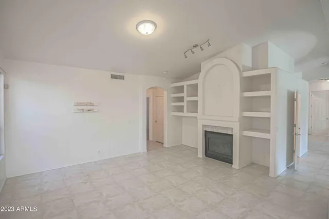 a view of a hallway with entryway and chandelier