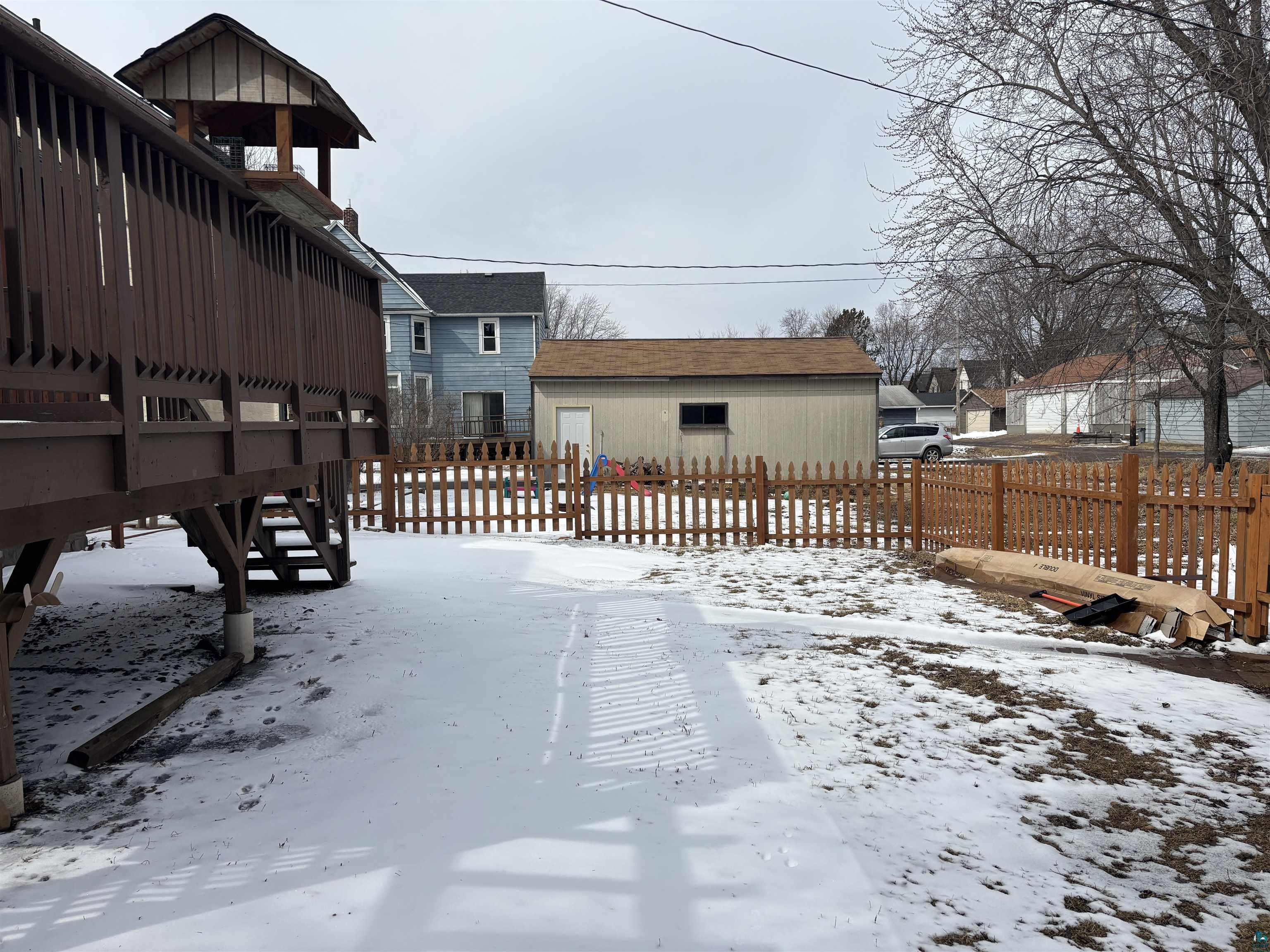 21 4th Street Proctor, MN 55810 - Photo 4 of 35 Yard covered in snow with fence