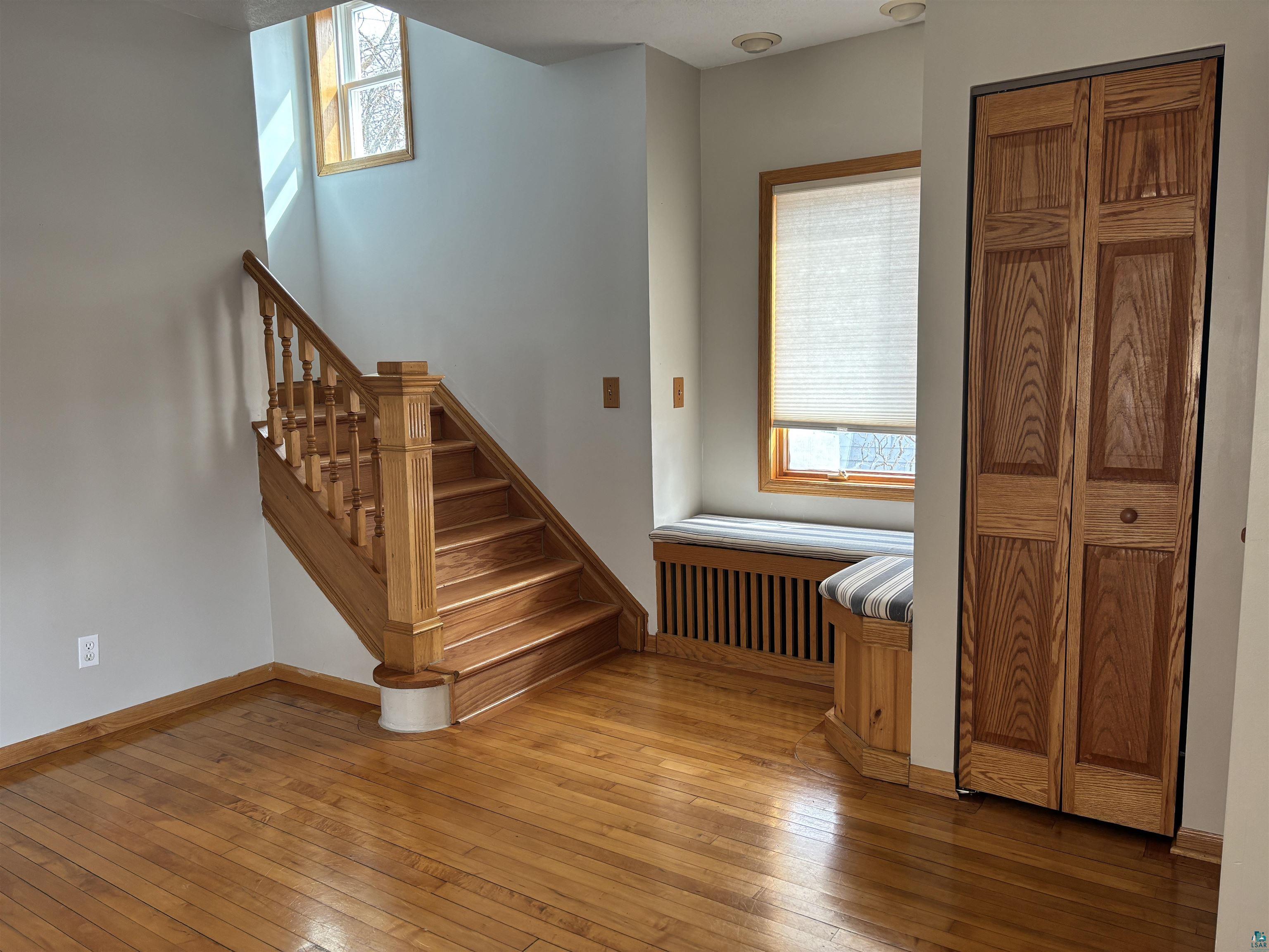 21 4th Street Proctor, MN 55810 - Photo 9 of 35 Staircase with wood-type flooring, radiator, and baseboards