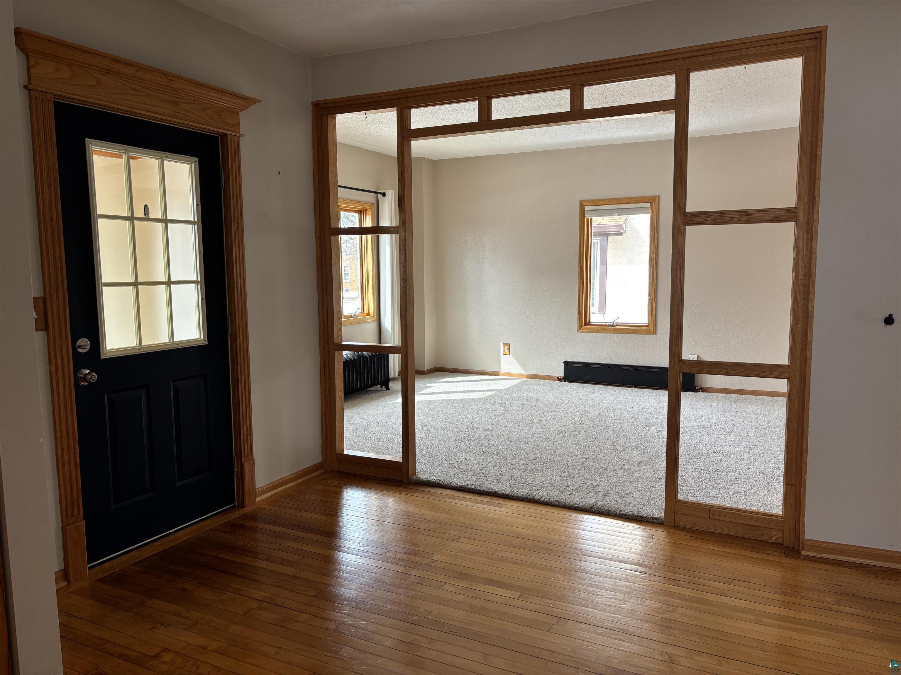 21 4th Street Proctor, MN 55810 - Photo 10 of 35 Entrance foyer featuring wood-type flooring, baseboards, and radiator