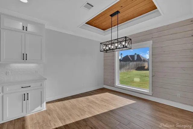 a kitchen with stainless steel appliances granite countertop white cabinets and a stove