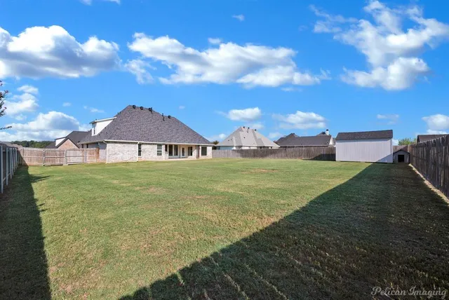 a front view of a house with a garden and yard