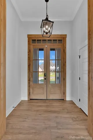 a view of a room with wooden floor and ceiling fan