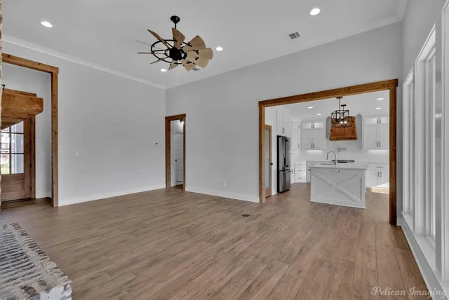 a view of a hallway view with wooden floor and workspace