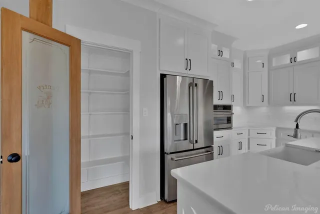 a kitchen with stainless steel appliances a refrigerator and cabinets