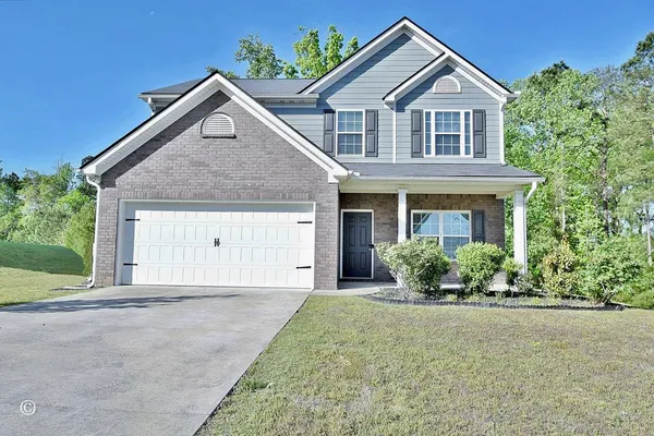 a front view of a house with a yard