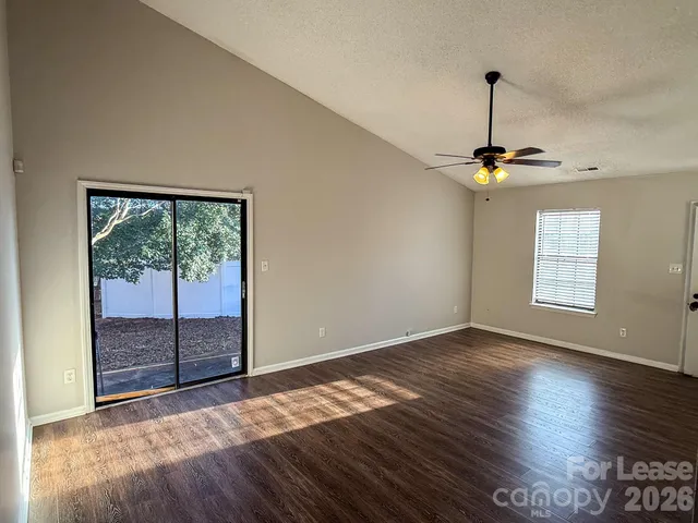 a view of an empty room with glass door and balcony