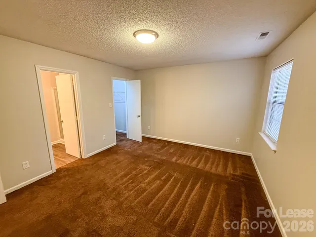 a view of an empty room and wooden floor