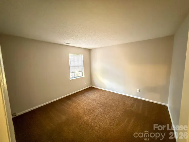 an empty room with a empty space and a window
