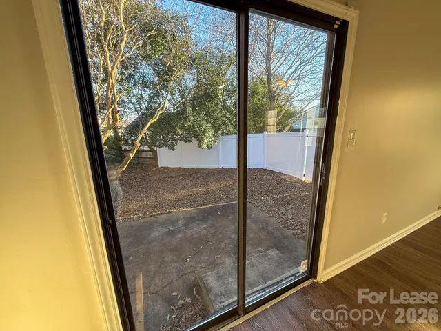 a view of a glass door with a tree