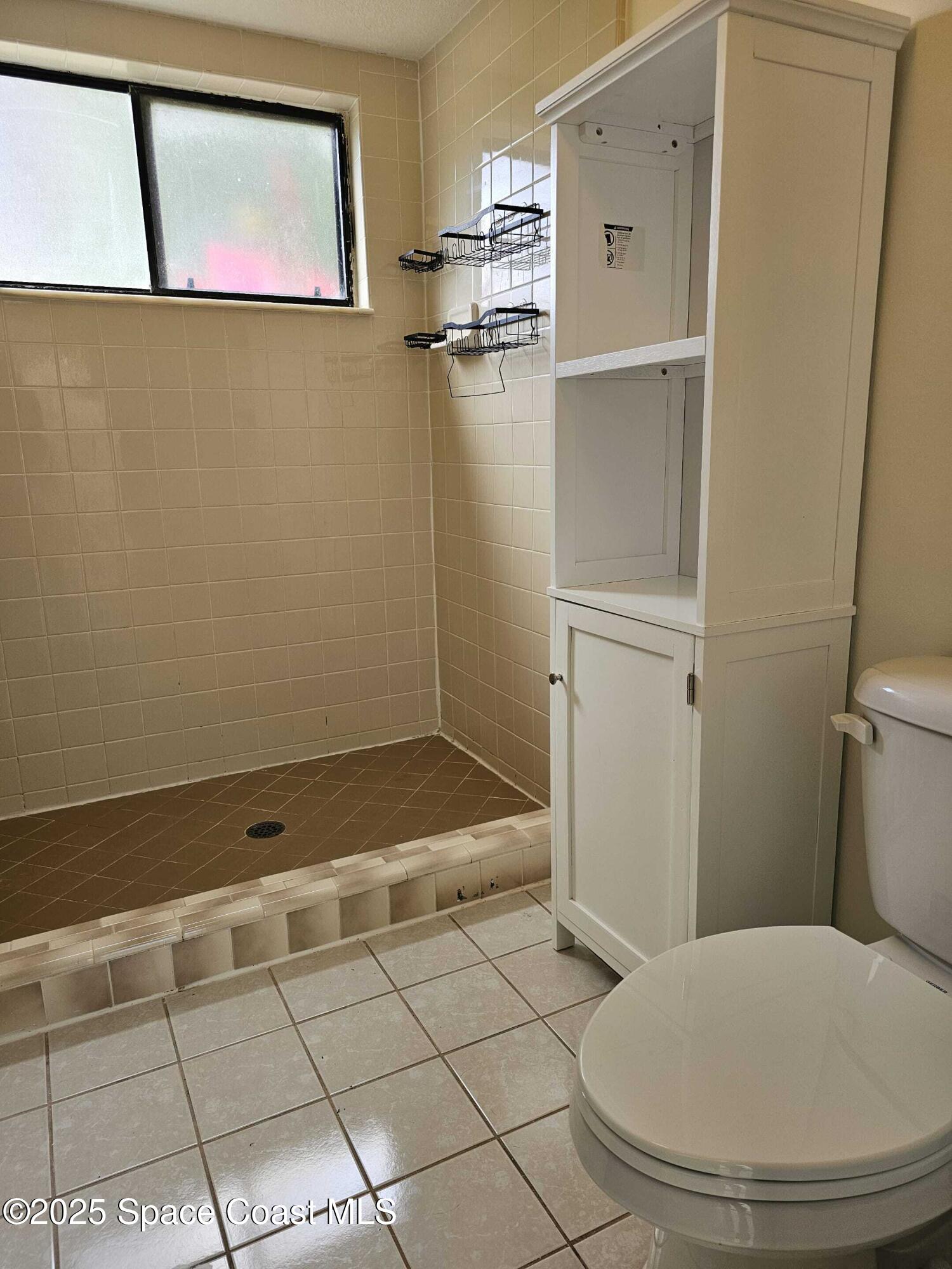391 Cypress Point Drive Melbourne, FL 32940 - Photo 12 of 28 a bathroom with a sink and a toilet