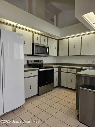 a kitchen with stainless steel appliances a stove sink and refrigerator