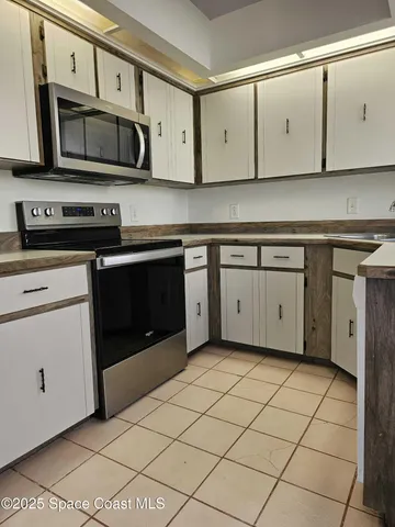 a kitchen with stainless steel appliances granite countertop a stove a microwave and cabinets