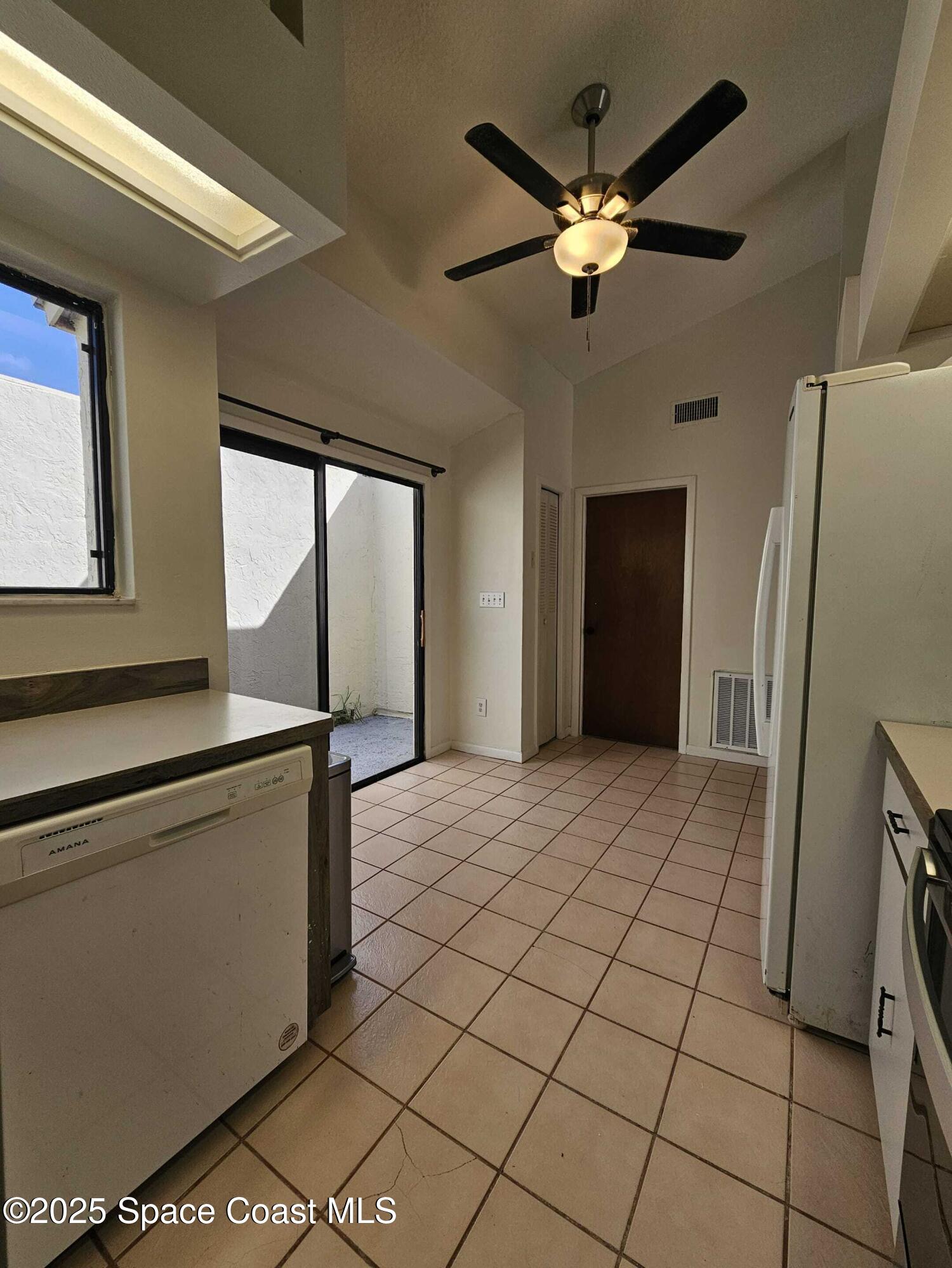 391 Cypress Point Drive Melbourne, FL 32940 - Photo 16 of 28 a kitchen with stainless steel appliances a refrigerator and a fireplace