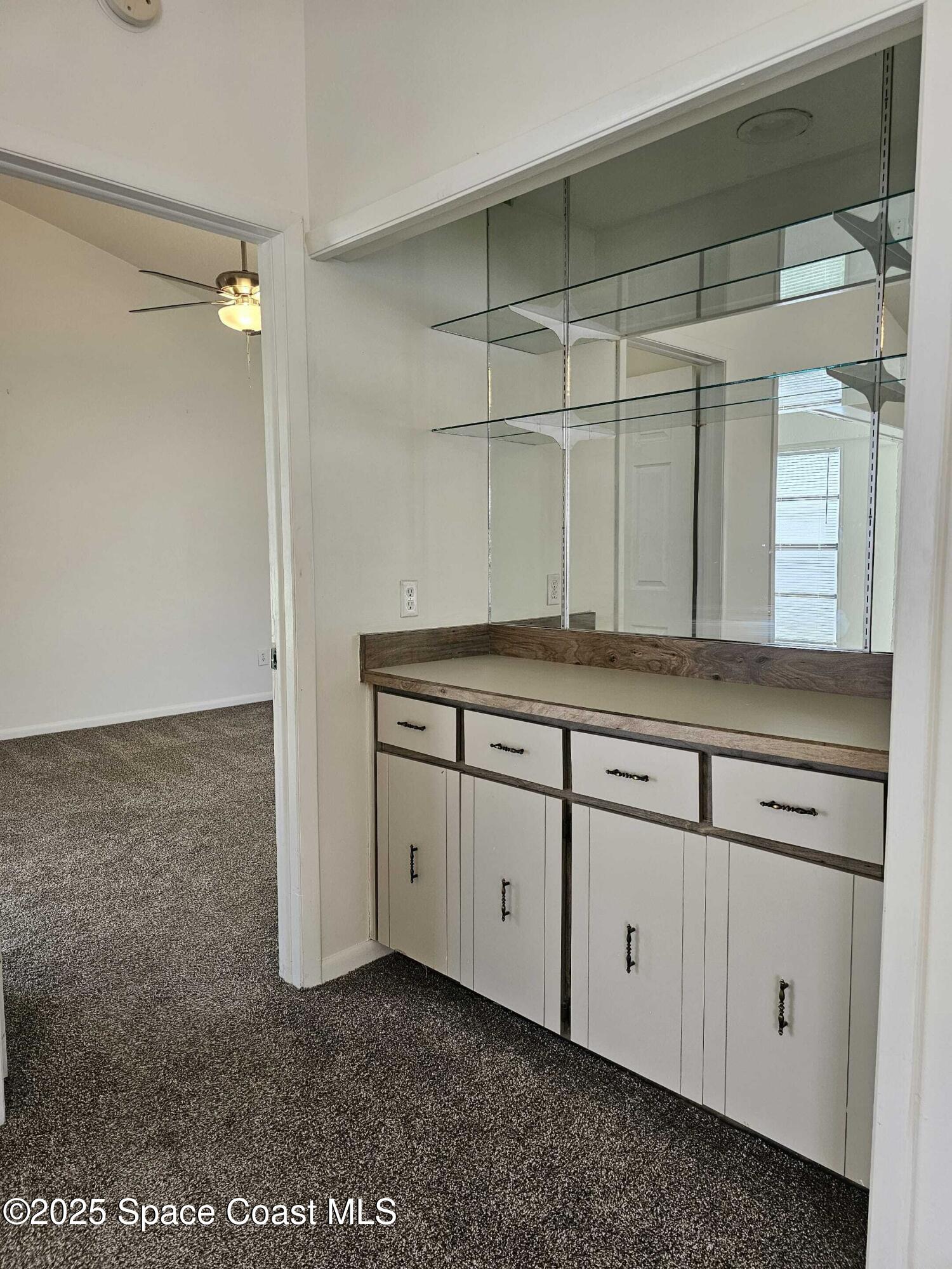 391 Cypress Point Drive Melbourne, FL 32940 - Photo 18 of 28 a bathroom with a granite countertop sink and a mirror