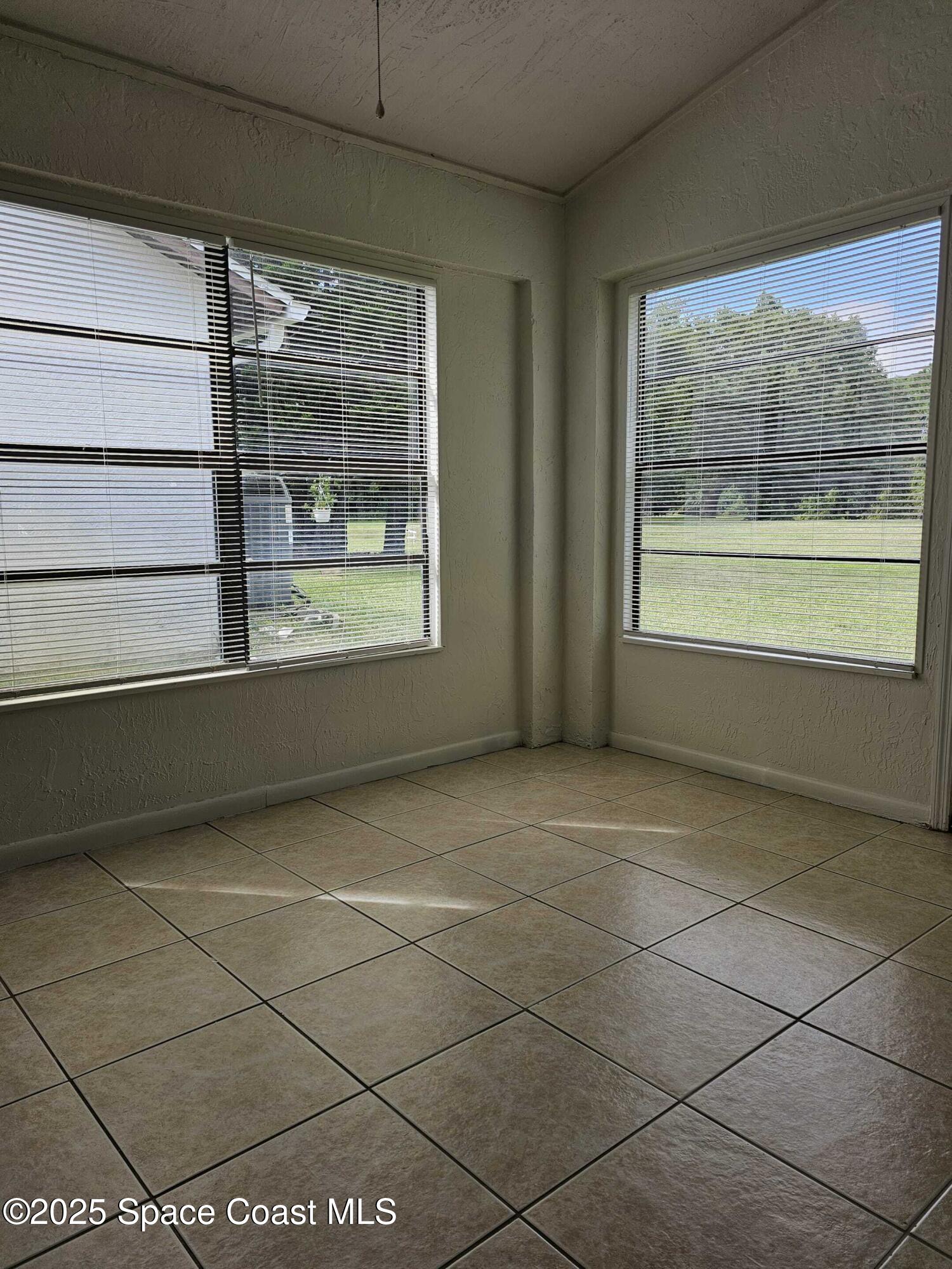 391 Cypress Point Drive Melbourne, FL 32940 - Photo 19 of 28 a view of an empty room with a window