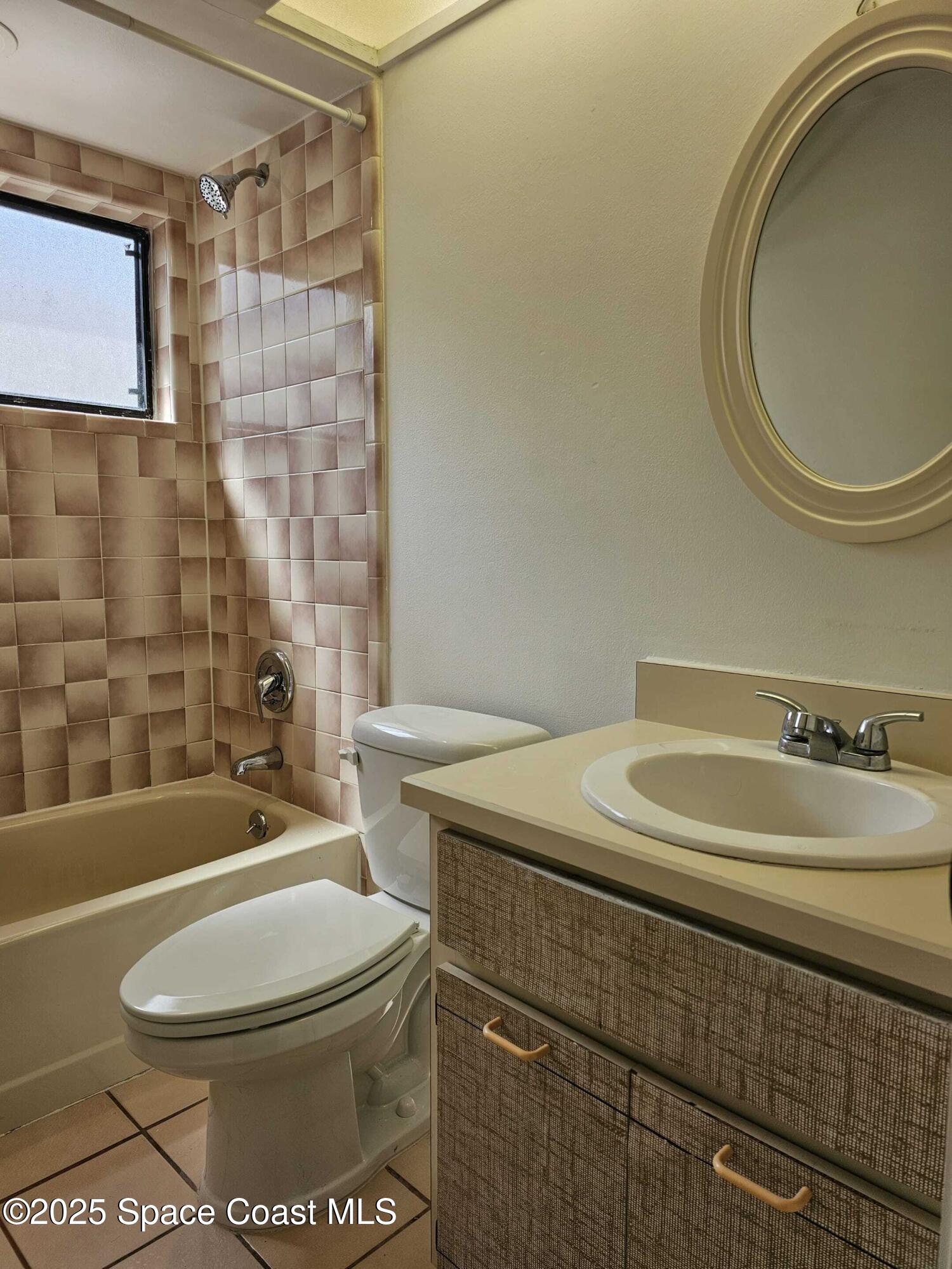 391 Cypress Point Drive Melbourne, FL 32940 - Photo 22 of 28 a bathroom with a sink a toilet and shower